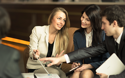 Image a group of people looking at a document