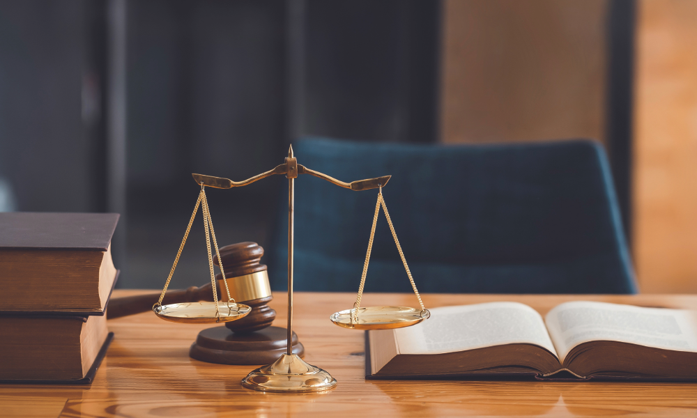 Image of a gavel, a legal scale and law books.